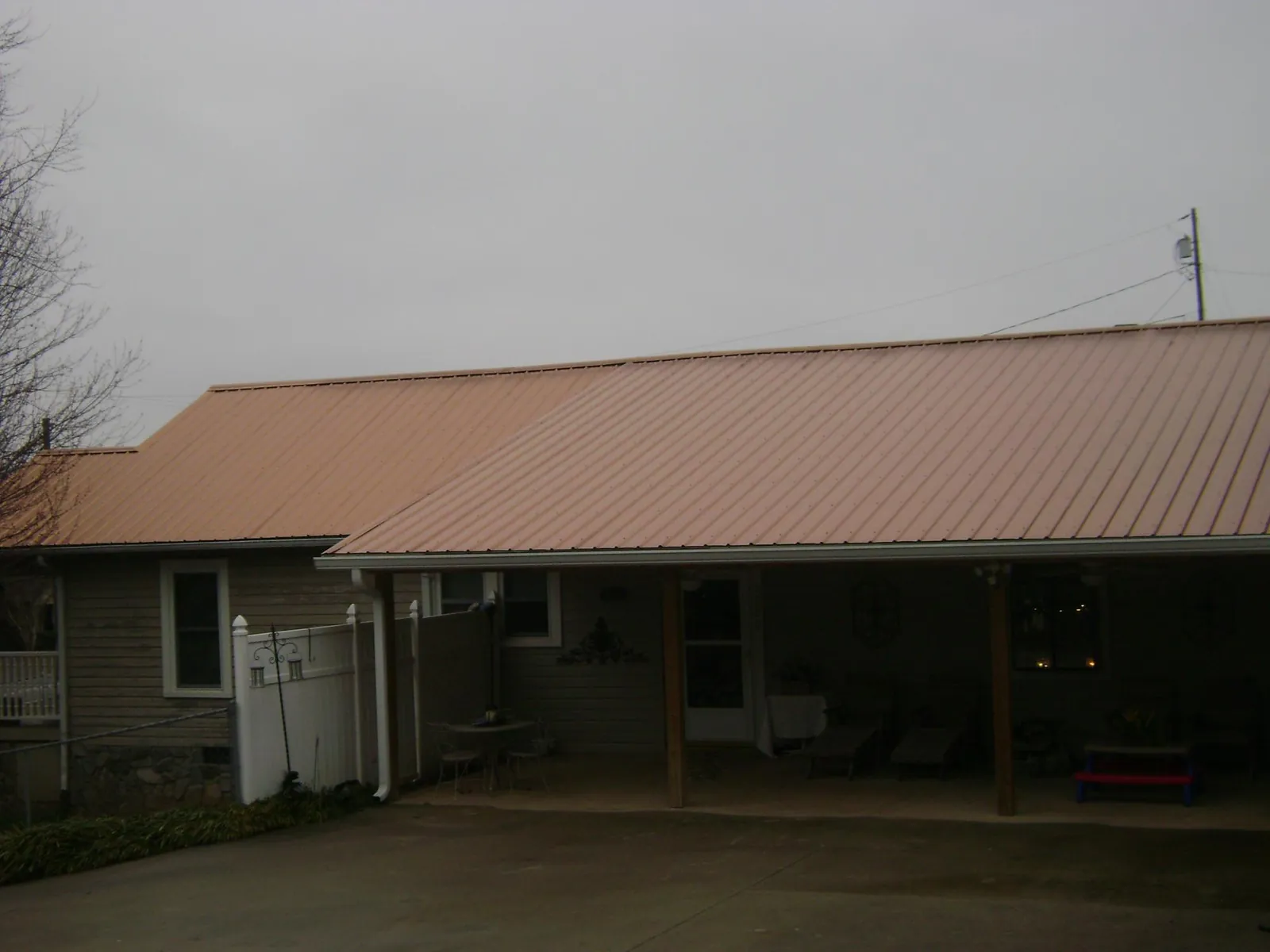 Copper toned metal roof over a wide covered patio in Miami